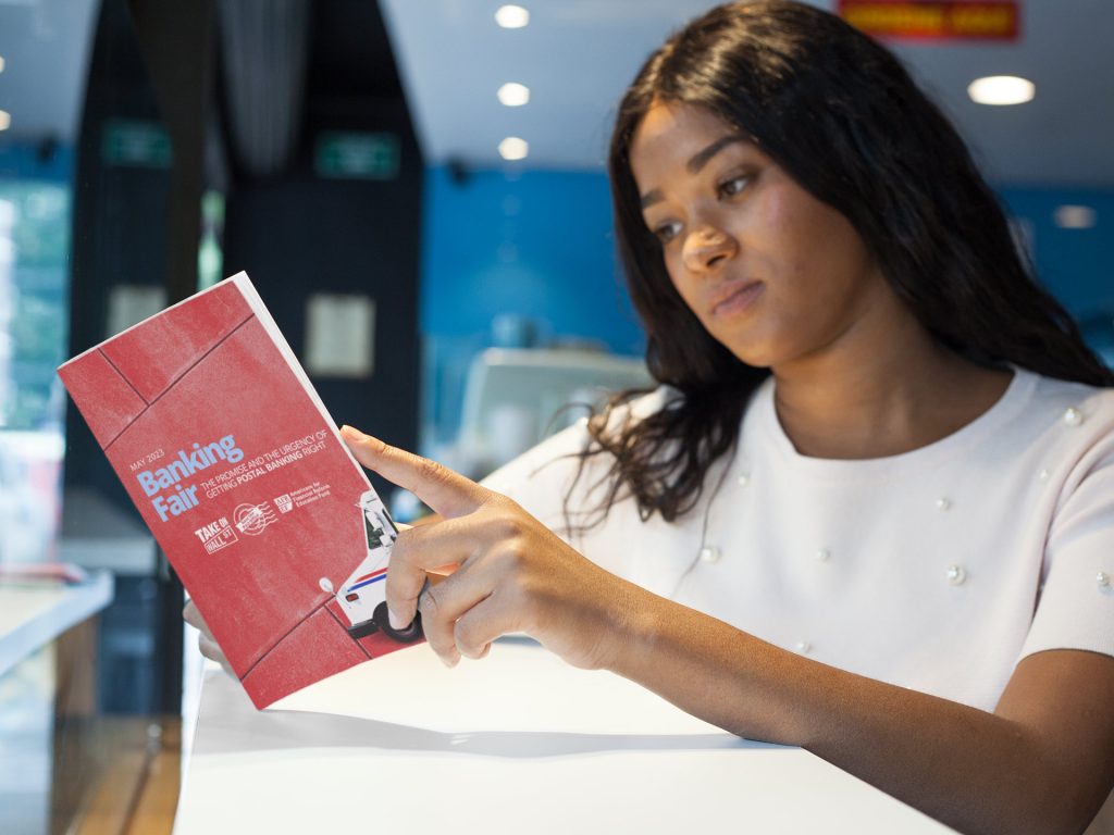 Young woman reads the postal banking report