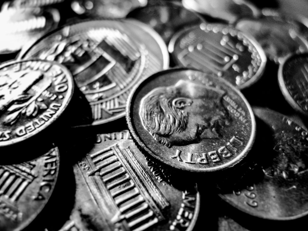 pile of coins in black and white